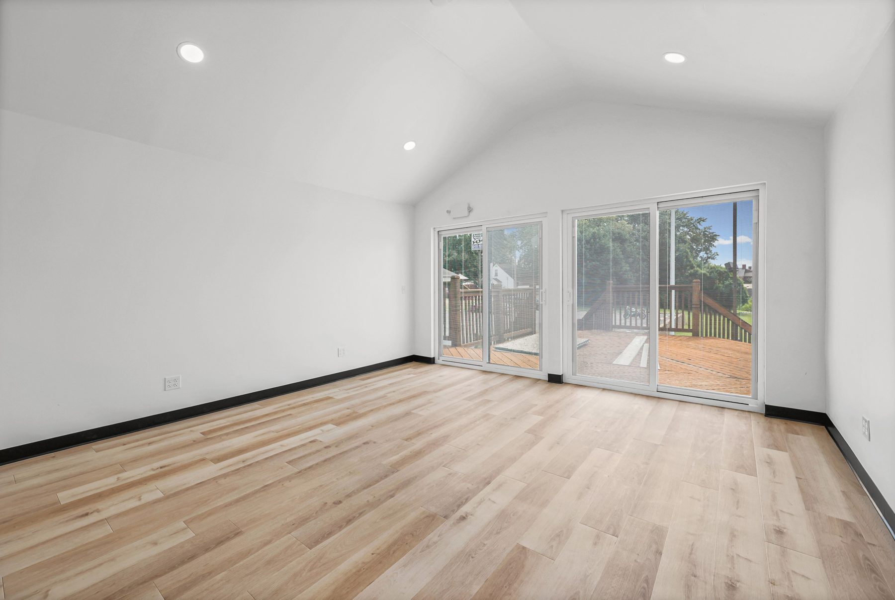 Empty salon suite with patio doors and natural light
