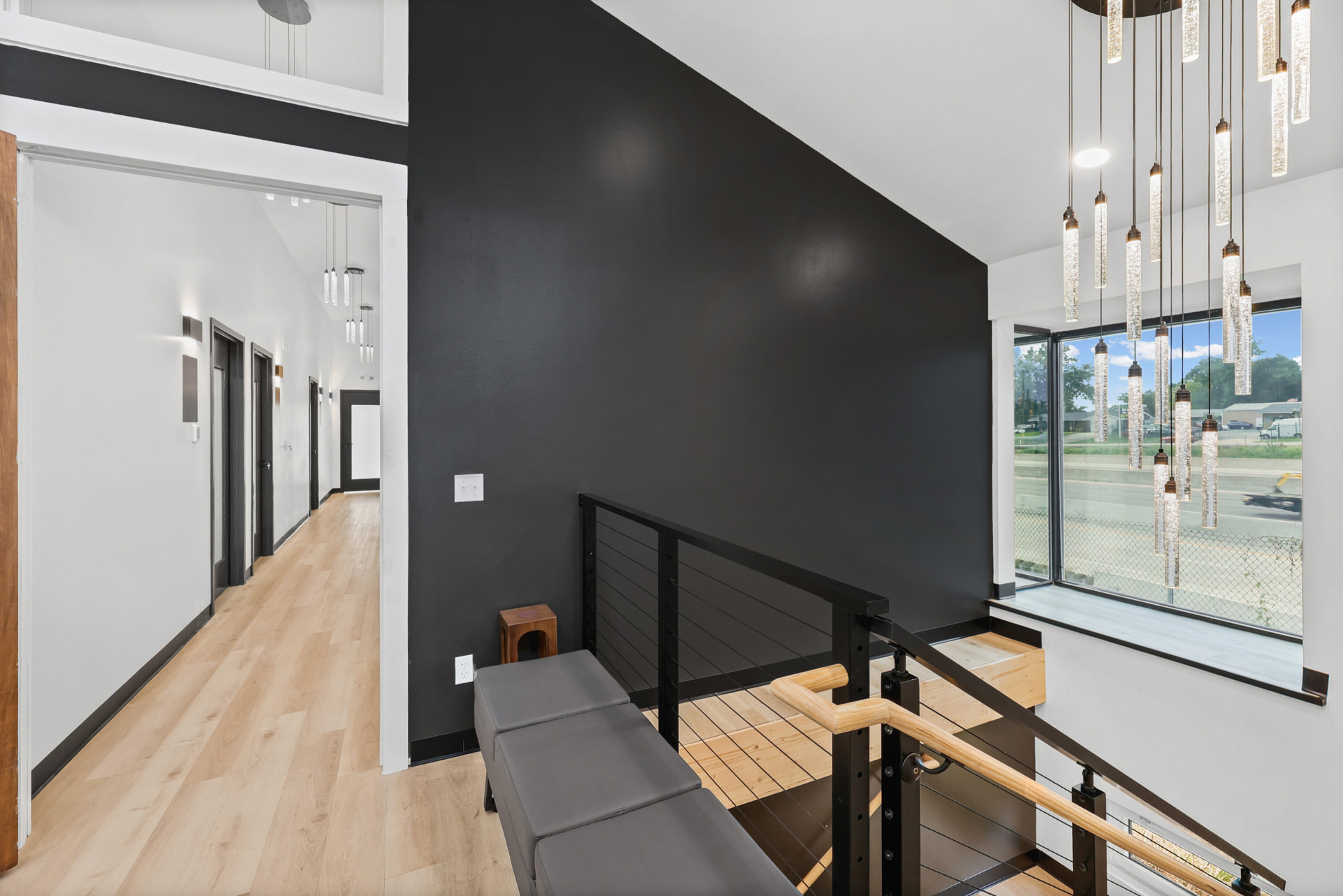 Bright, modern hallway and staircase inside Suites of St. Charles